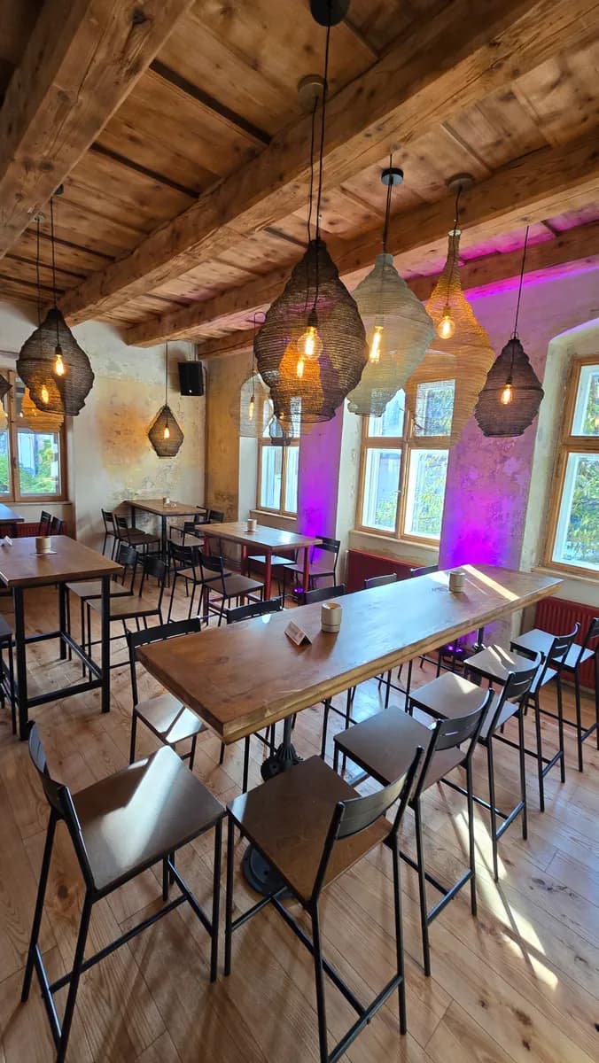 Tables and hanging lights upstairs at Bodega Wine Bar